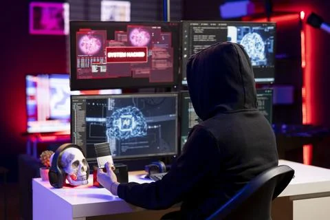 Hacker looking at SSD with malware on computer, using it to break into systems 写真素材