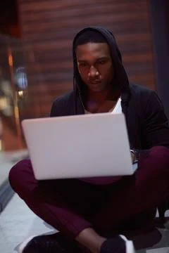 Hacker, man and typing with laptop on floor for phishing, install ransomwar.. Stock Photos