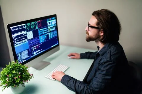 Hacker man attack the server sitting at the desk 写真素材