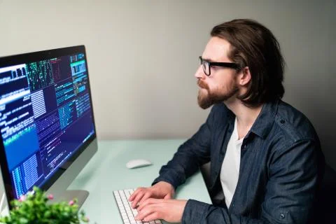 Hacker man attack the server sitting at the desk 写真素材