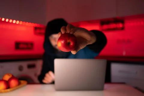 Hacker a man with a beard at a laptop Stock Photos