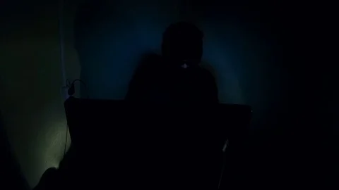 Hacker man in black mask and black gloves on the computer uses a keyboard Stock Footage 87146953