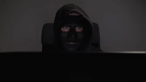 Hacker, man in mask with laptop, typing malicious code, breaching online se.. Stock Footage 278026300