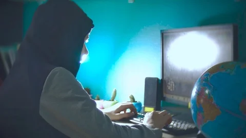 Hacker man programmer in the hood using computer for hack information and data Stock Footage 88437830