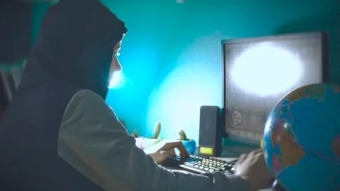 Hacker man programmer in the hood using computer laptop for hack information and Stock Footage 88564281