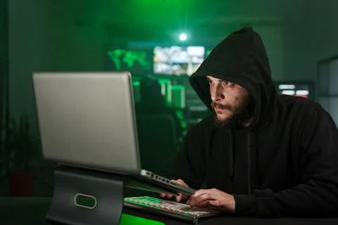 Hacker man typing on laptop, hacking computer system with virus Stock Photos