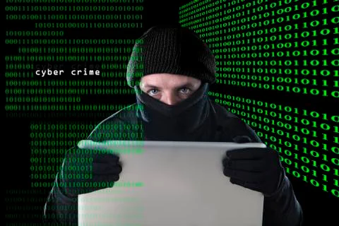 Hacker man using computer laptop for criminal cyber crime hacking Stock Photos