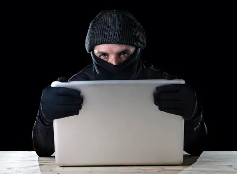 Hacker man using computer laptop for criminal activity hacking password Stockfoto's