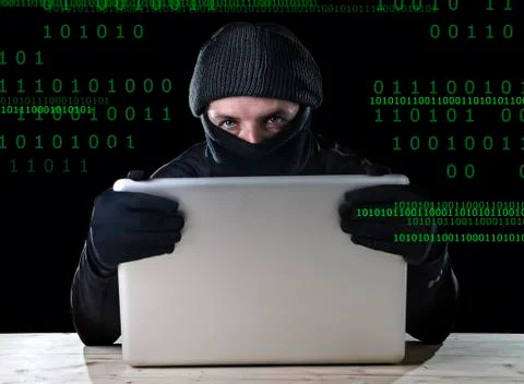 Hacker man using computer laptop for criminal activity hacking password Stock Photos