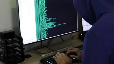 A hacker man writes the azure code for an attack. Program a virus with your c Stock Footage 143873498