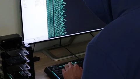 A hacker man writes the azure code for an attack. Program a virus with your c Stock Footage 144050296