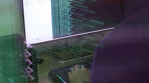 A hacker man writes the azure code for an attack. Program a virus with your c Stock Footage 145691961