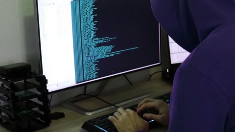 A hacker man writes the blue code for an attack. Program a virus with your co Stock Footage 143873376