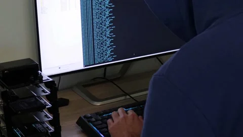 A hacker man writes the blue code for an attack. Program a virus with your co Stock Footage 144050224