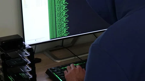 A hacker man writes the green code for an attack. Program a virus with your c Stock Footage 143673666