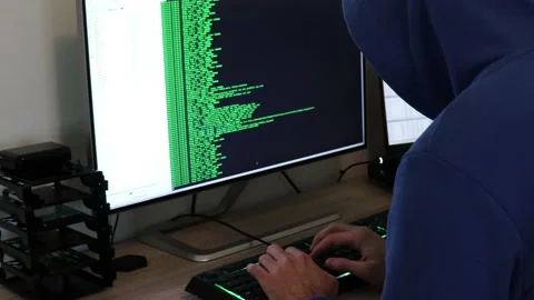 A hacker man writes the green code for an attack. Program a virus with your c Stock Footage 143673773