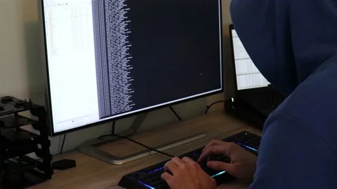 A hacker man writes the green code for an attack. Program a virus with your c Stock Footage 143673934