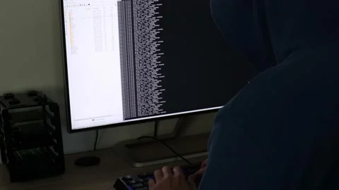 A hacker man writes the green code for an attack. Program a virus with your c Stock Footage 143673957
