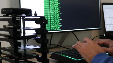 A hacker man writes the green code for an attack. Program a virus with your c Stock Footage 143676404