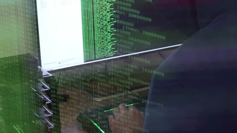 A hacker man writes the green code for an attack. Program a virus with your c Stock Footage 144125215