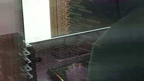 A hacker man writes the orange code for an attack. Program a virus with your  Stock Footage 145691738