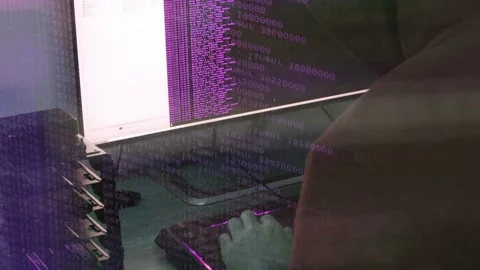 A hacker man writes the purple code for an attack. Program a virus with your  Stock Footage 145691576