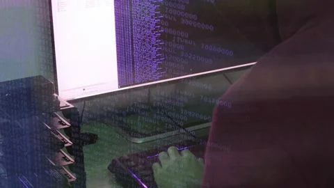 A hacker man writes the violet code for an attack. Program a virus with your  Stock Footage 145691480
