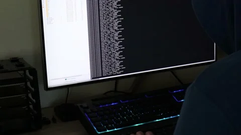A hacker man writes the white code for an attack. Program a virus with your c Stock Footage 143674850