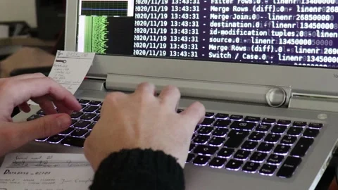 A hacker man writes the white code for an attack. Program a virus with your l Stock Footage 144126329