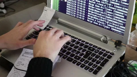 A hacker man writes the white code for an attack. Program a virus with your l Stock Footage 144126443