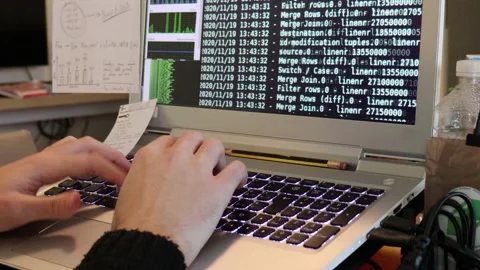 A hacker man writes the white code for an attack. Program a virus with your l Stock Footage 144126762