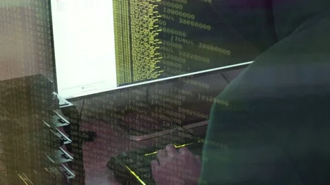 A hacker man writes the yellow code for an attack. Program a virus with your  Stock Footage 145691393