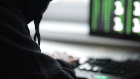 Hacker in mask at computer,cyberattacks world servers,steals data,hacks secur Stock Footage 166350012
