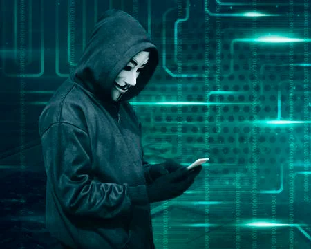 Hacker with mask touching a smartphone screen Stock Photos