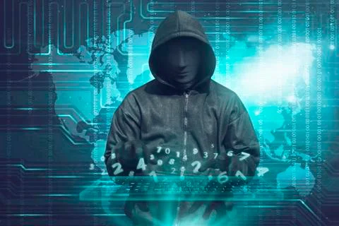 Hacker in mask typing keyboard hacking binary data Stock Photos