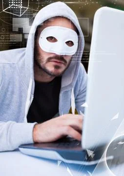 Hacker with a mask using a laptop 写真素材