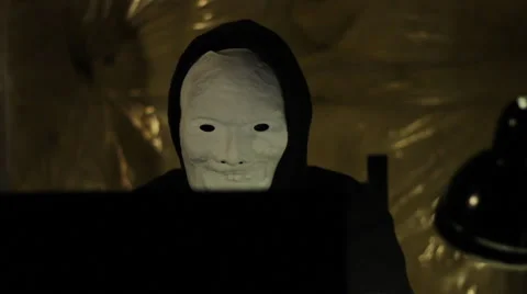 Hacker in mask working on computer Stock Footage 43713030