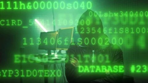 Hacker with masked face working on a computer for cyber attack while green Stock-Footage 120666246