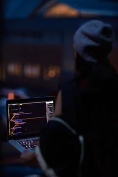 Hacker, night and programming with person and laptop screen for ransomware Stock-Fotos