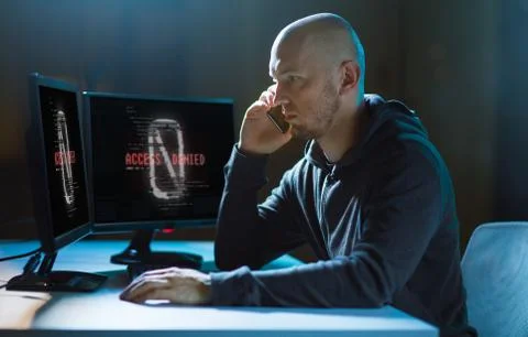 Hacker with no access on computer calls on cell 스톡 사진