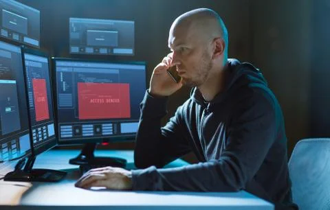 Hacker with no access on computer calls on cell 스톡 사진