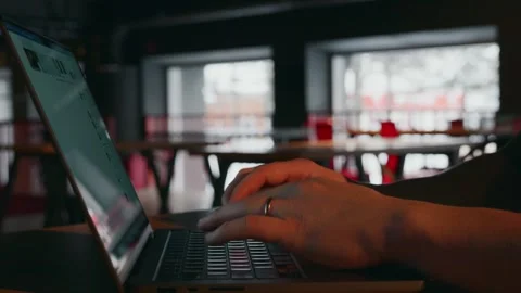 A hacker opens a laptop and starts working, typing text on the keyboard Video stock 258612428