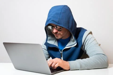 Hacker or developer in blue hoodie coding Stock Photos