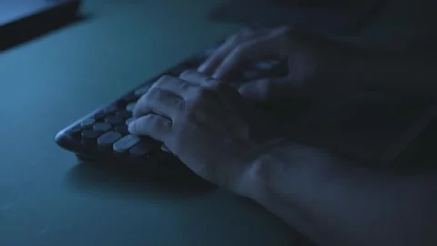 Hacker or programmer typing code fast on a keyboard in low light, cyber sec.. Stock-Footage 342236940