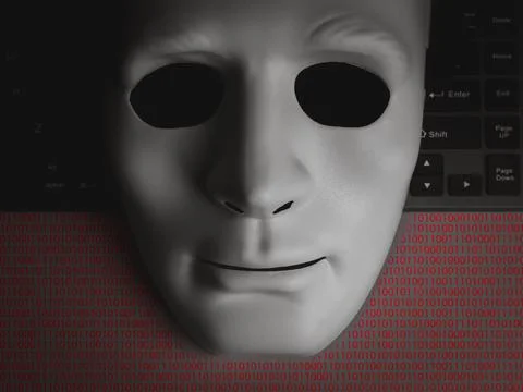 Hacker or scammer concept with white anonymous human mask on black keyboard.. 스톡 사진