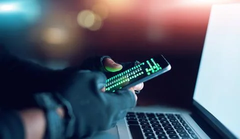 Hacker, phone and coding on laptop at night for hacking software database Fotos de archivo