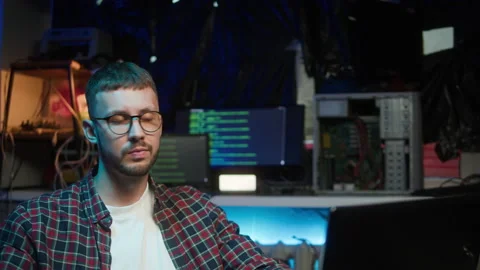 Hacker playing rubik's cube. Young man relaxing after developing program Stock Footage 190143448