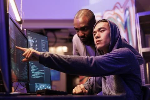 Hacker pointing at malware on screen Stock Photos