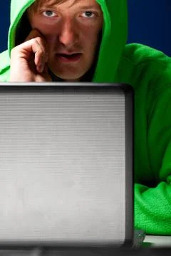 Hacker portrait hacker. Young man with laptop is talking phone ,model rele... Stock-Fotos