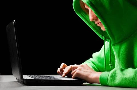 Hacker portrait hacker. Young man with laptop is looking at screen ,model ... Stock-Fotos